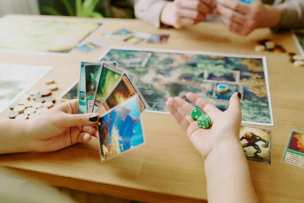 Hands holding cards and dice at a tabletop game