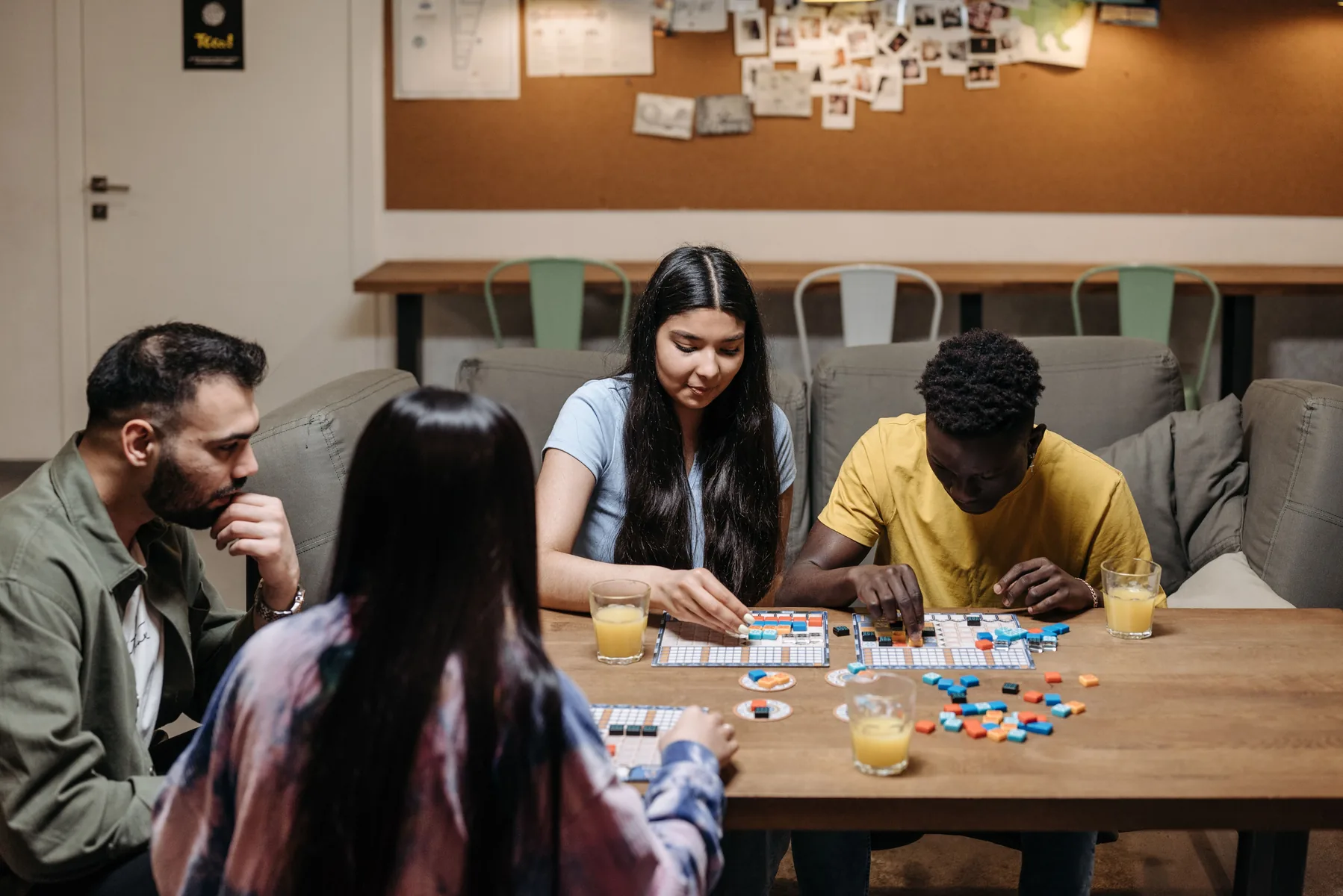 A group playing a tabletop game in a welcoming room